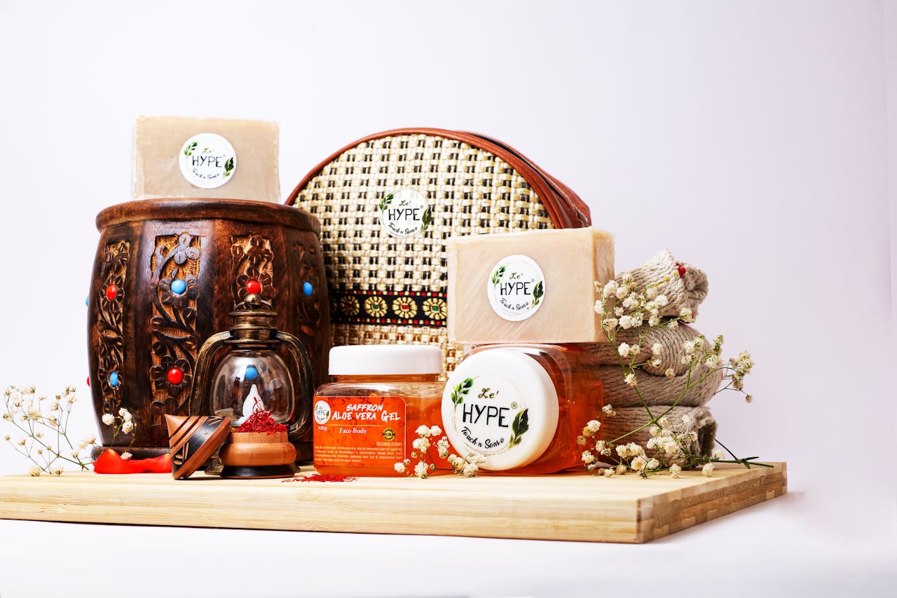 about-01 A collection of natural skincare products with herbal soap and accessories on a wooden background.