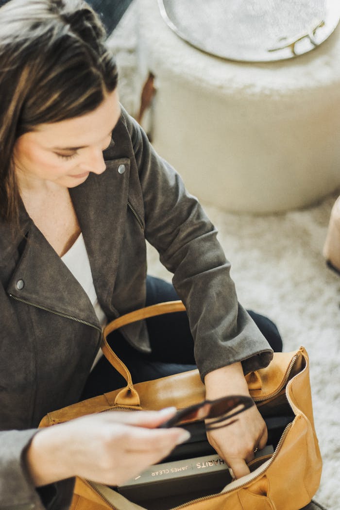 Modern woman organizing leather tote with essentials in South Carolina.