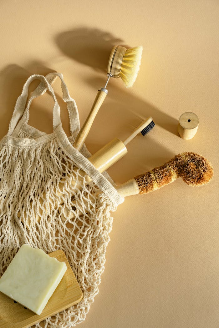 hero-img-01 Natural wooden and bristle cleaning brushes with soap in a net bag